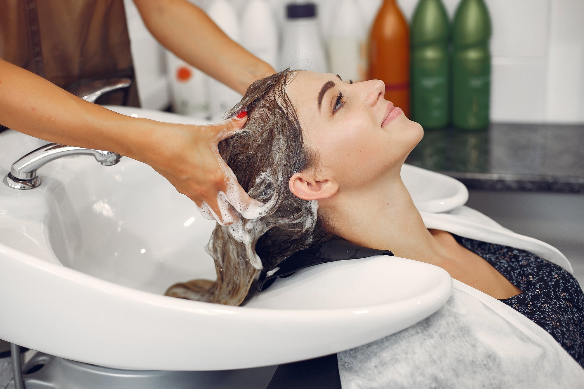 The Beauty wizard salon Premium Spa chamber with soothing warm candles, lush green botanical leaves, and pink orchids