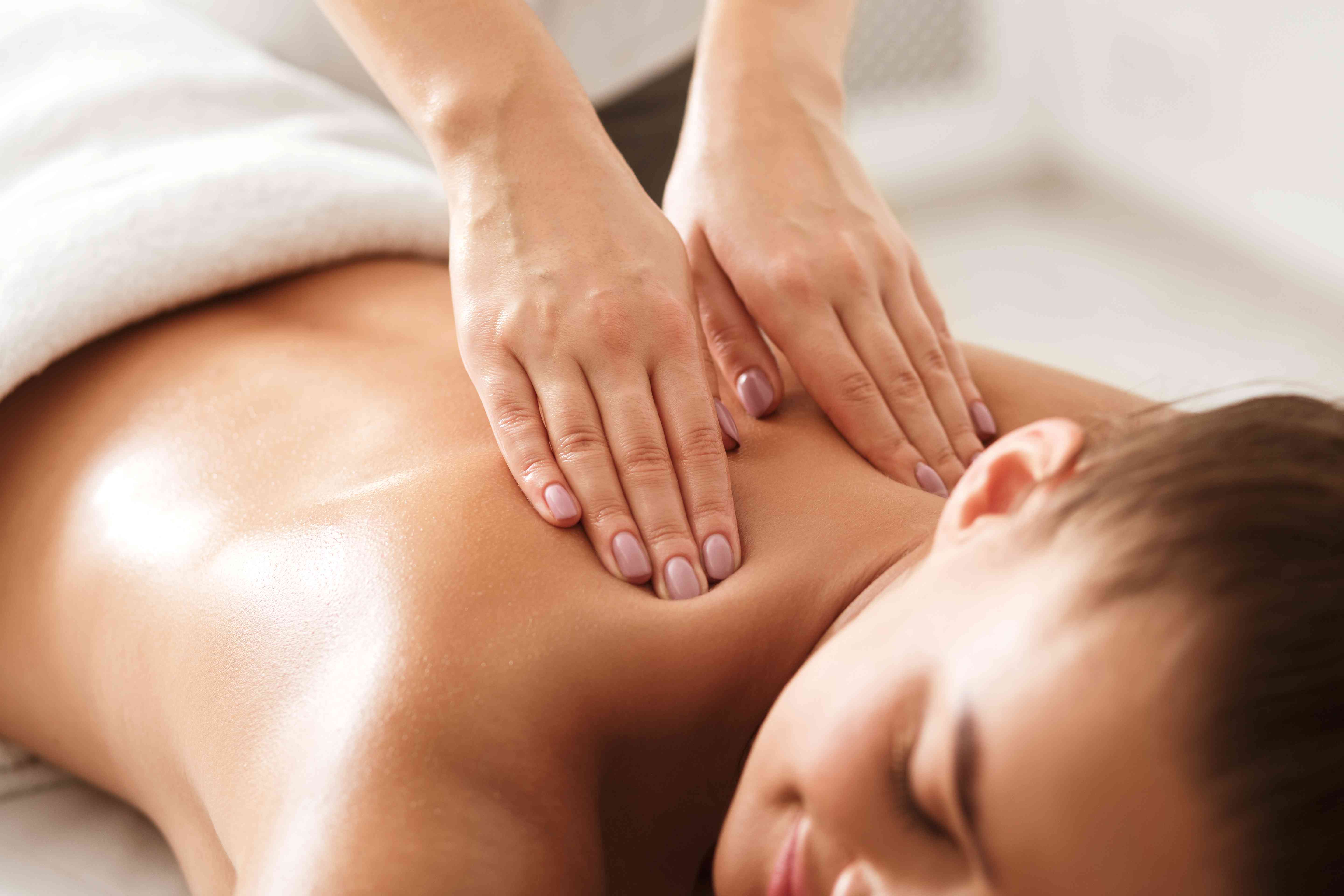 Soothing candles and orchids in spa therapy chamber